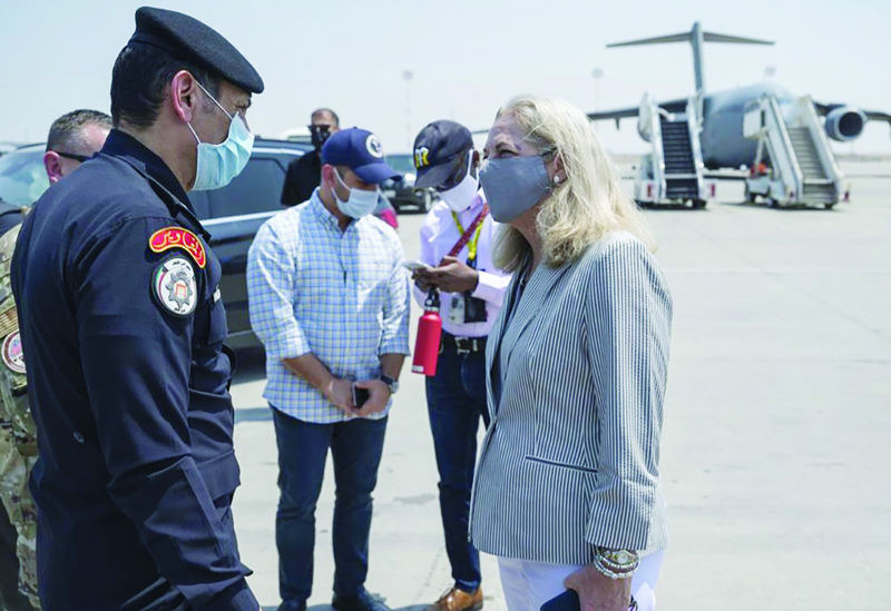 KUWAIT: A handout picture released by the US embassy in Kuwait shows American Ambassador in Kuwait Alina Romanowski talking to military personnel as she checks on US evacuees from Afghanistan transiting through Kuwait.-AFPn