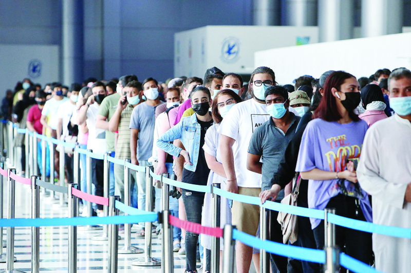 KUWAIT: People queue to receive a dose of the COVID-19 vaccine at Kuwait Vaccination Center at the fairgrounds in Mishref yesterday. More than 2.5 million citizens and residents have received at least one dose of the vaccine so far, the health minister said a day earlier. - Photo by Yasser Al-Zayyat n