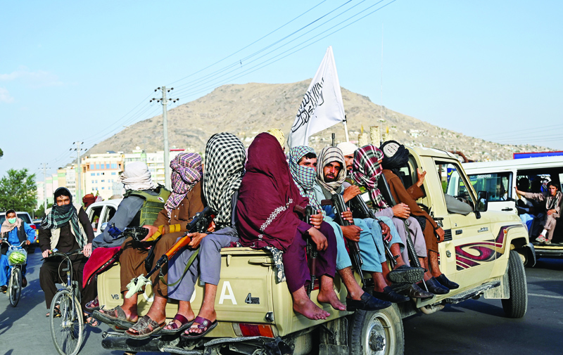 KABUL: Taleban fighters in a vehicle patrol the streets of Kabul yesterday. - AFPn