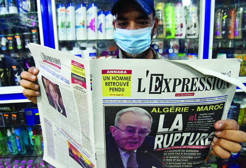 ALGIERS: An Algeria man holds yesterday's newspaper in the capital Algiers yesterday. – AFPn