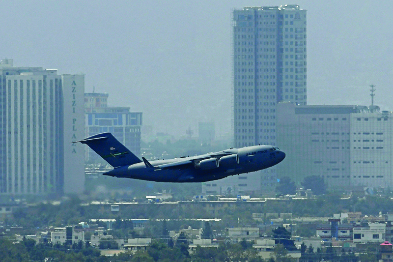KABUL: A US Air Force aircraft takes off from the airport in Kabul yesterday. Rockets were fired at Kabul Airport where US troops were racing to complete their withdrawal from Afghanistan.-AFPn