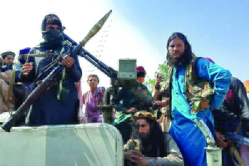 Taleban fighters are seen in a town in Laghman province yesterday. - AFP n