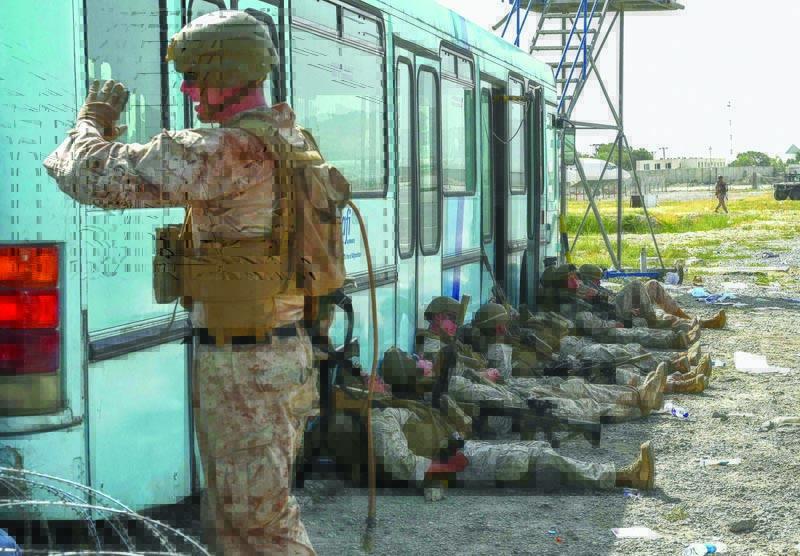 KABUL: US soldiers rest at Kabul airport yesterday. - AFP n