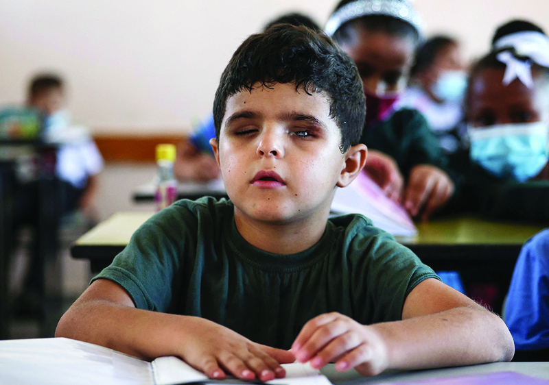 GAZA: Palestinian pupil Mohammed Shaban sits alongside classmates at a school in Beit Lahia yesterday. nn