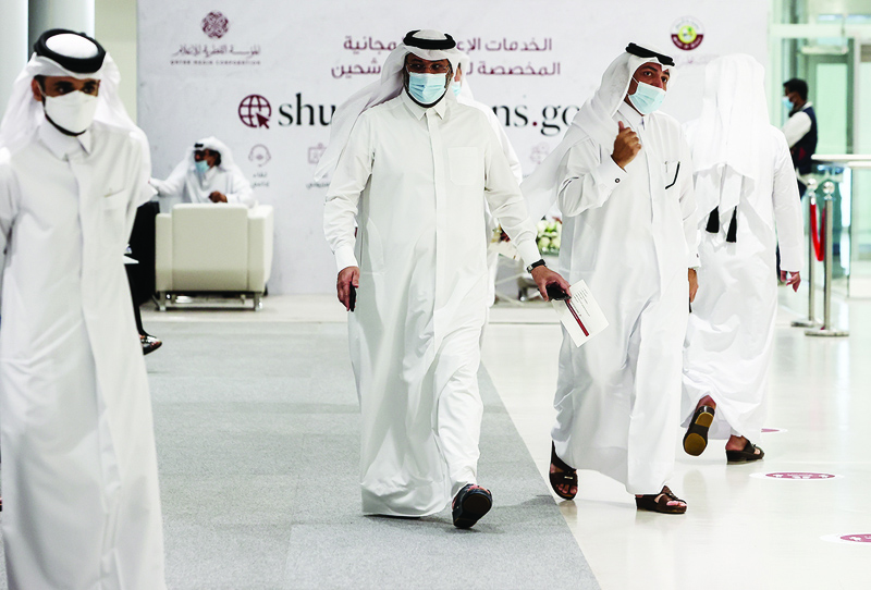 DOHA: Candidates leave after registering to run in the country's upcoming election to the Shura Council in Doha Sunday.-AFPn