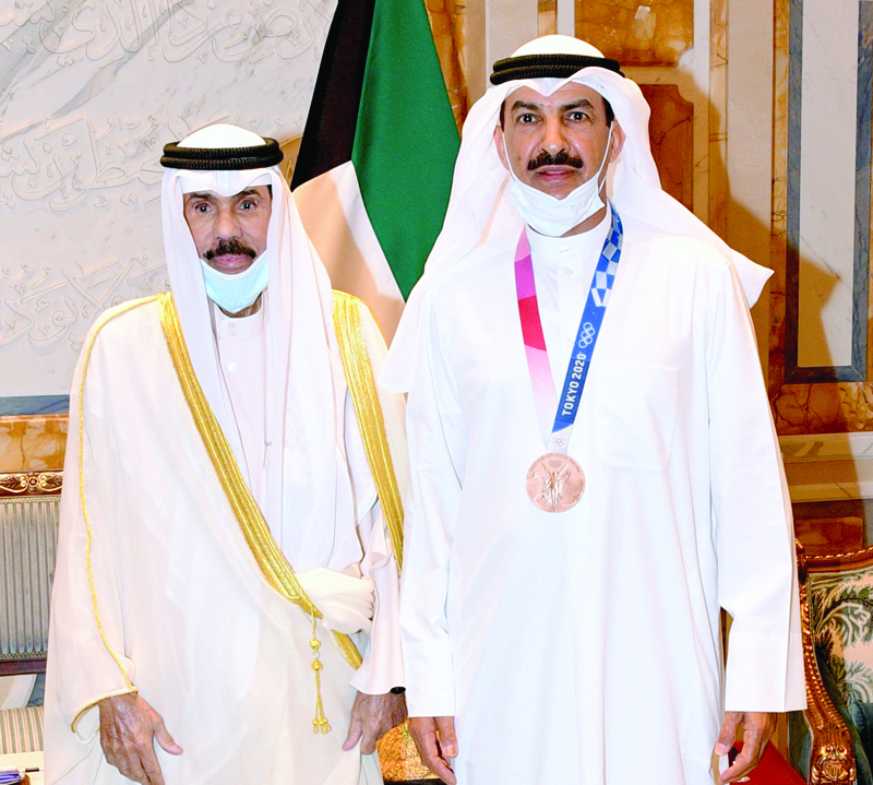 KUWAIT: His Highness the Amir Sheikh Nawaf Al-Ahmad Al-Jaber Al-Sabah with Tokyo 2020 Olympics bronze medal winner Abdullah Turqi Al-Rashidi. - Amiri Diwan photon