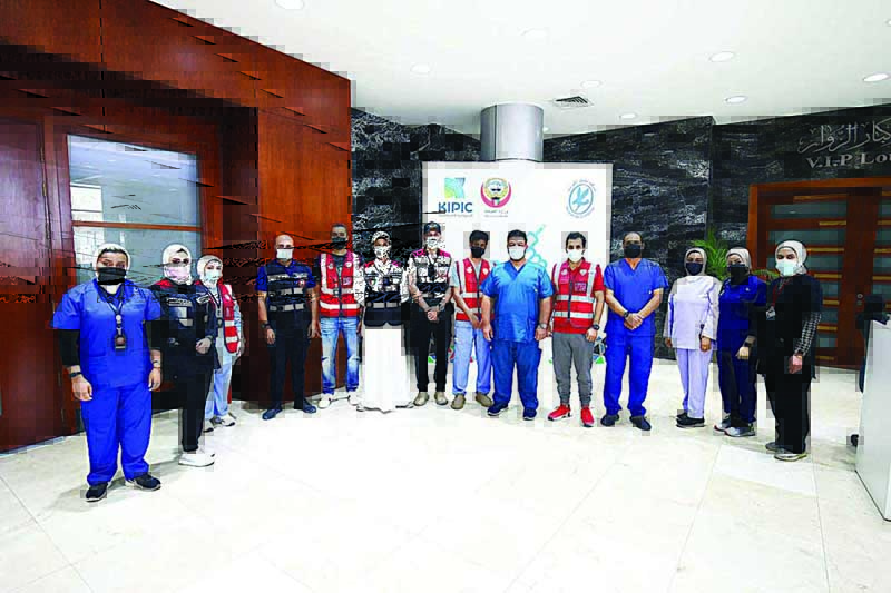 KUWAIT: Health Ministry members pose for a group photo at the Kuwait Vaccination Center in Mishref. - Photos by Yasser Al-Zayyatn