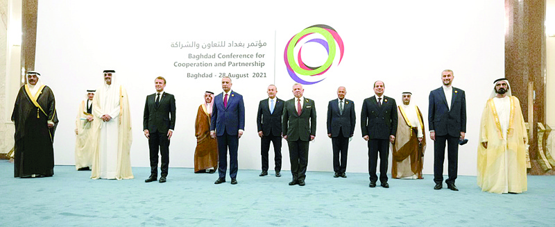 BAGHDAD: His Highness the Prime Minister Sheikh Sabah Al-Khaled Al-Hamad Al-Sabah (left) appears in a group photo taken on the sidelines of the Baghdad Conference for Partnership and Cooperation in Baghdad yesterday. - KUNAn