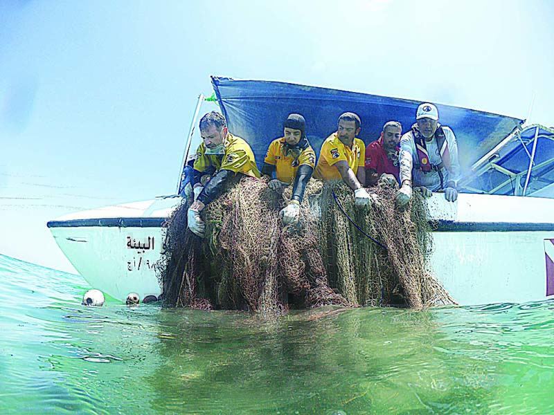 KUWAIT: Members of the Kuwait Dive Team lift fishing nets during a cleaning campaign in this archive photo.n