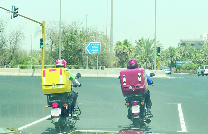 KUWAIT: This file photo shows two delivery motorbikes at a traffic light in Kuwait.n