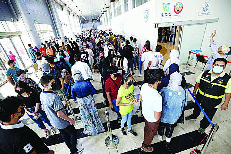 KUWAIT: People queue to receive a dose of the COVID-19 vaccine at the Kuwait Vaccination Center yesterday. - Photos by Yasser Al-Zayyatn