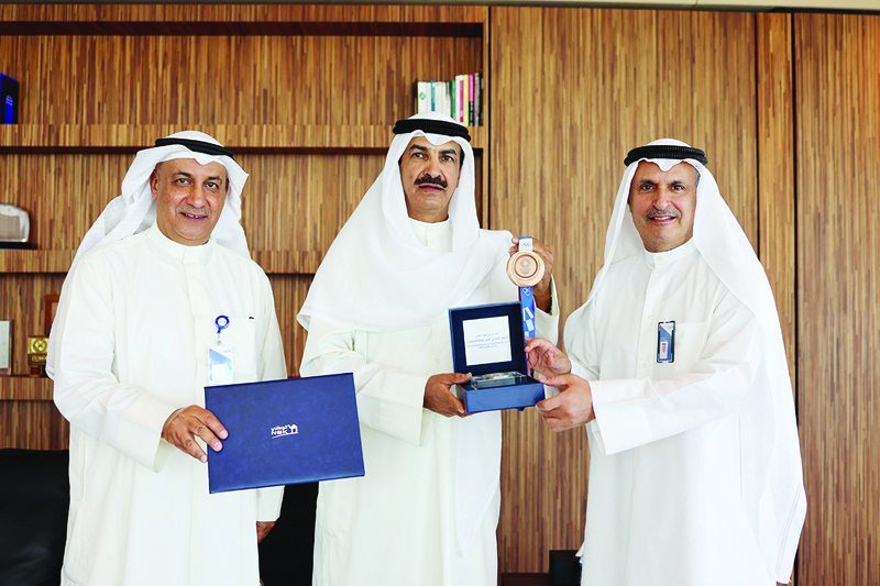 KUWAIT: Isam Al-Sager, NBK Group CEO, and Salah Al-Fulaij, NBK- Kuwait CEO, honor Kuwaiti shooter Abdullah Al-Rashidi.nn
