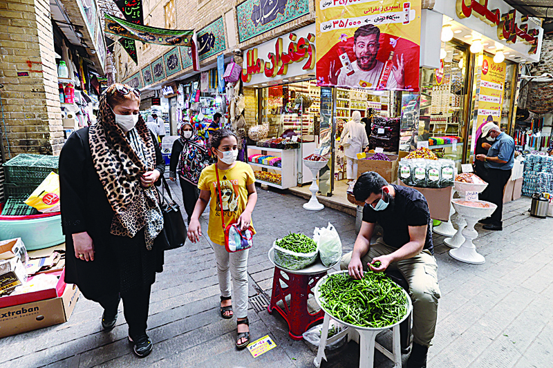 TEHRAN, Iran: Mask-clad Iranians shop at the Tajrish Bazaar market in the capital Tehran, yesterday. - AFPn