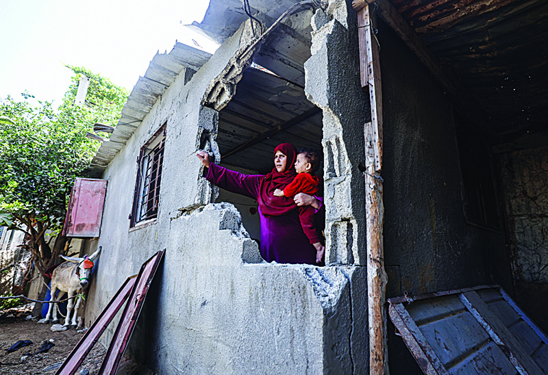 BEIT HANUN, Palestinian Territories: A Palestinian woman inspects the damage at her house following Zionist bombing in Beit Hanoun in the northern Gaza Strip yesterday. ¨CAFPn
