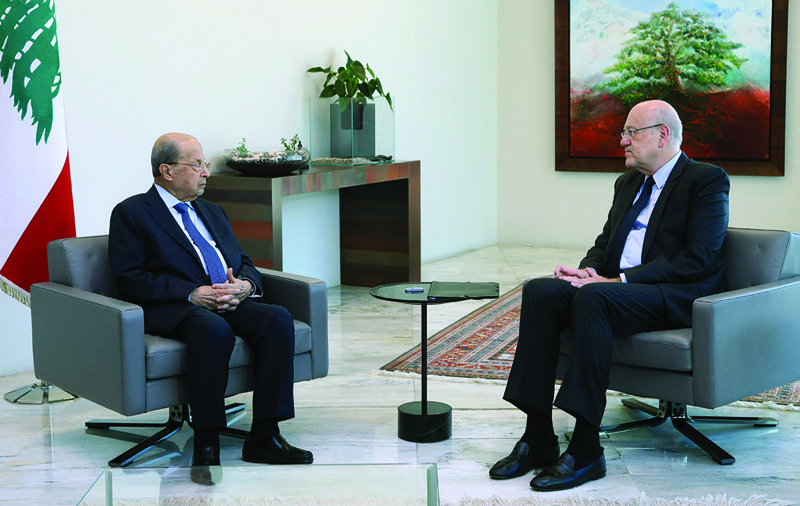 BAABDA, Lebanon: A handout picture provided by the Lebanese photo agency Dalati and Nohra shows Lebanon's President Michel Aoun meeting with premier-designate Najib Mikati at the presidential palace in Baabda, east of the capital Beirut, yesterday. - AFPn