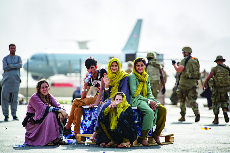 KABUL: In this image courtesy of the US Marine Corps, evacuee children wait for the next flight after being manifested at Hamid Karzai International Airport, Kabul.-AFPnn
