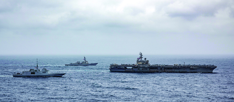 AT SEA: This handout photo courtesy of US Navy and made available shows (left to right) French navy frigate FS Languedoc (D653), guided-missile destroyer USS Halsey (DDG 97), and aircraft carrier USS Ronald Reagan (CVN 76) steaming in formation in the Arabian Sea. - AFPn