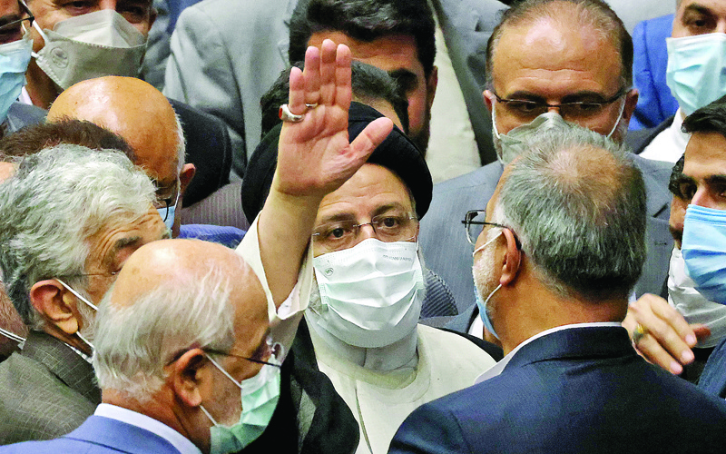 TEHRAN: Iran's newly-elected President Ebrahim Raisi (center) waves during his swearing in ceremony at the Iranian parliament in the capital Tehran yesterday. - AFPn