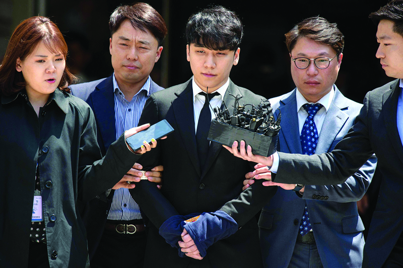 This file photo shows former BIGBANG boyband member Seungri (center), real name Lee Seung-hyun, taken into custody as he leaves the High Court in Seoul. — AFP photosn