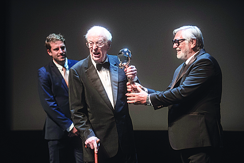 British film actor Michael Caine is handed the Crystal Globe Award for the Outstanding Artistic Contribution to the World of Cinema by the president of the Karlovy Vary International Film Festival Jiri Bartoska, during the opening of the 55th Karlovy Vary International Film Festival (KVIFF) in Karlovy Vary.-AFP photosn