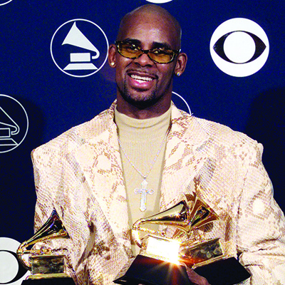 In this file photo R. Kelly holds his three Grammy Awards in New York at the 40th annual Grammy Awards.—AFP n