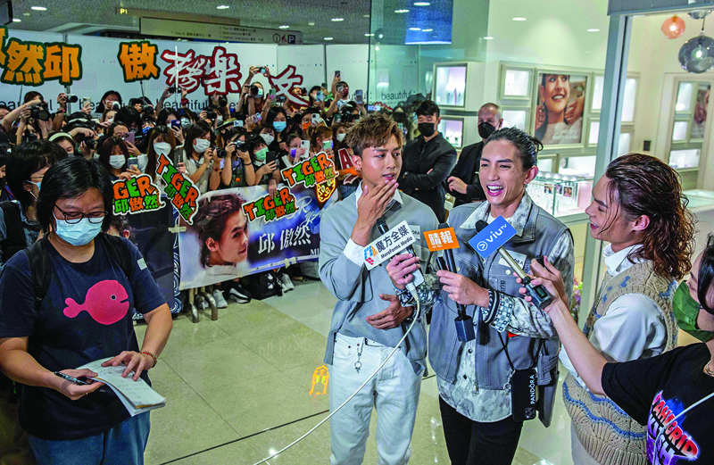 This picture shows Anson Kong (center), Lok Man Yeung (second right) and Tiger Yau (right) , members of Cantopop boyband Mirror, speaking with the media during an event at a shopping mall in Hong Kong.  – AFP photosn