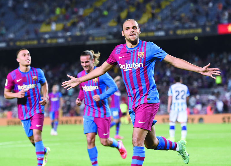 BARCELONA: Barcelona's Danish forward Martin Braithwaite celebrates after scoring his second goal during the Spanish League football match between Barcelona and Real Sociedad at the Camp Nou stadium in Barcelona on Sunday. – AFPn