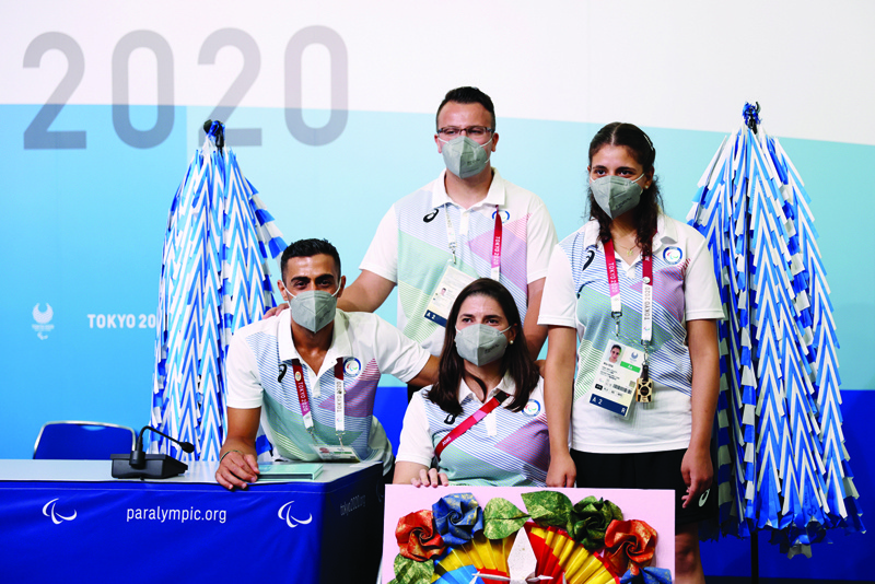 TOKYO: Members of the Paralympic Refugee team, Syrian-born Ibrahim al-Hussain (left), Iranian-born Shahrad Nasajpour (top-center), Syrian-origin Greece-born Alia Issa (right) and the team's chef de Mission Illeana Rodriguez (center) pose after a press conference in Tokyo yesterday, on the eve of the Tokyo Paralympic Games. - AFPn
