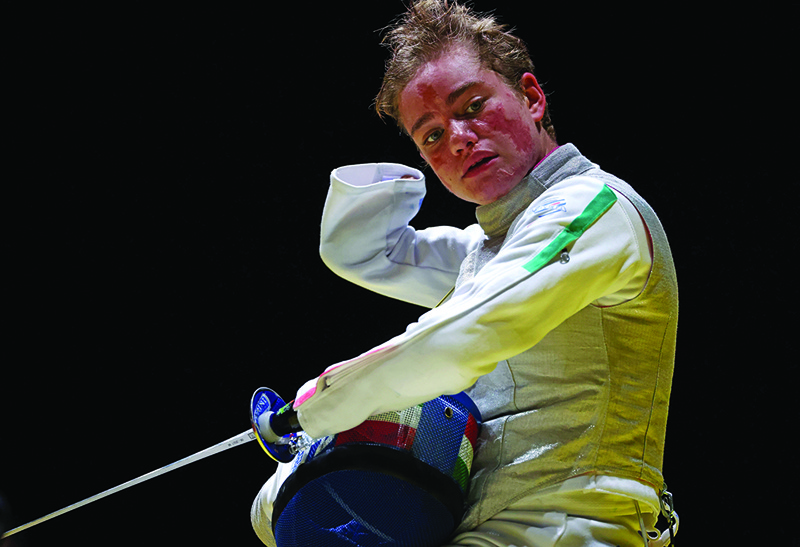 CHIBA: Italy's Beatrice Vio takes off her mask during a video review while competing against Russia's Ludmila Vasileva in the wheelchair fencing women's foil individual category B semi-final bout during the Tokyo 2020 Paralympic Games at Makuhari Messe Hall in Chiba yesterday. – AFPn