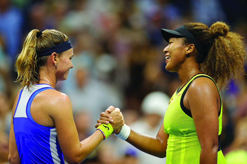NEW YORK: Naomi Osaka (right) of Japan shakes hands with Marie Bouzkova of the Czech Republic after winning during their Women's Singles first round match of the 2021 US Open on Monday. - AFPn