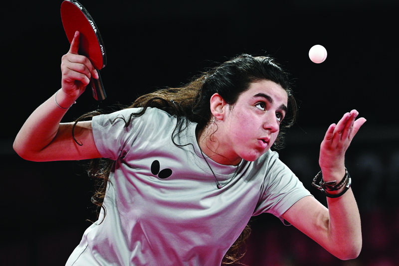 TOKYO: Syria's Hend Zaza eyes the ball as she serves to Austria's Liu Jia during their women's singles preliminary round table tennis match at the Tokyo Metropolitan Gymnasium during the Tokyo 2020 Olympic Games in Tokyo on July 24, 2021. - AFPn