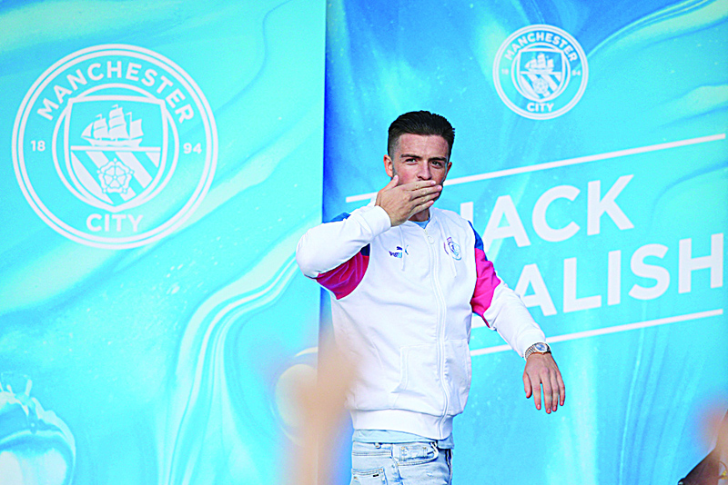 MANCHESTER: Jack Grealish waves to Manchester City fans outside the Etihad Stadium during his unveiling on Aug 9, 2021. - AFP n