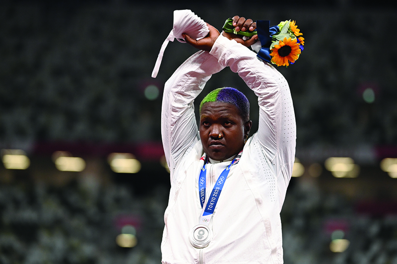 TOKYO: Second-placed USA's Raven Saunders gestures on the podium with her silver medal after completing the women's shot put event during the Tokyo 2020 Olympic Games at the Olympic Stadium in Tokyo on Sunday. - AFPn