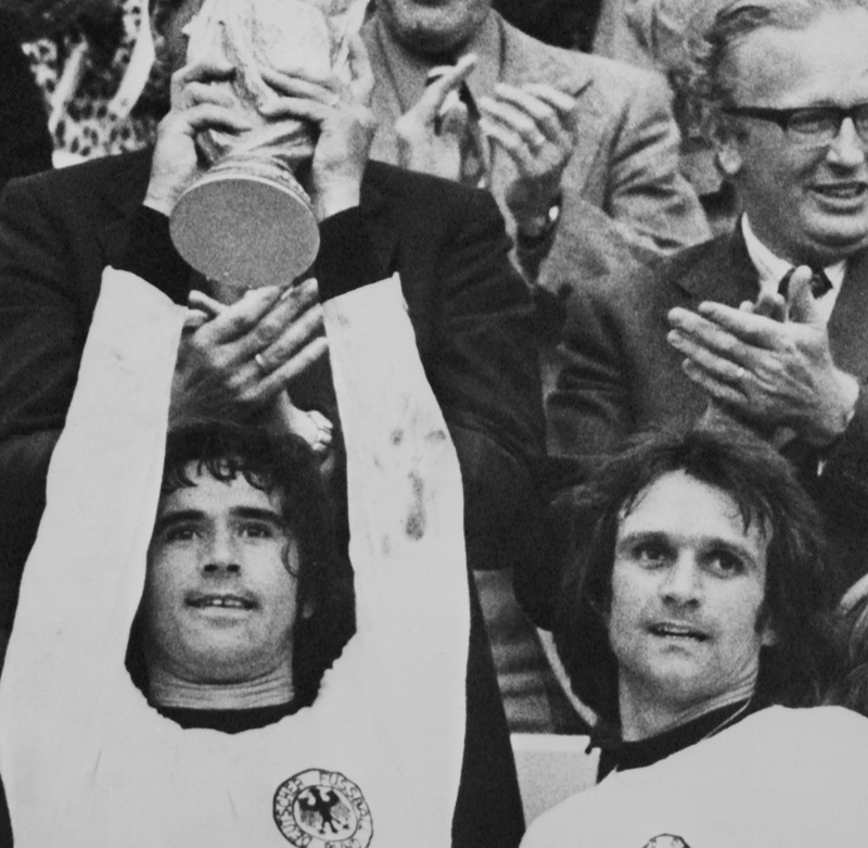 MUNICH: In this file photograph taken on July 7, 1974, West Germany's Gerd Mueller (left) raises the World Cup trophy after victory in the 1974 World Cup final between West Germany and Holland at The Olympic Stadium in Munich. - AFPn