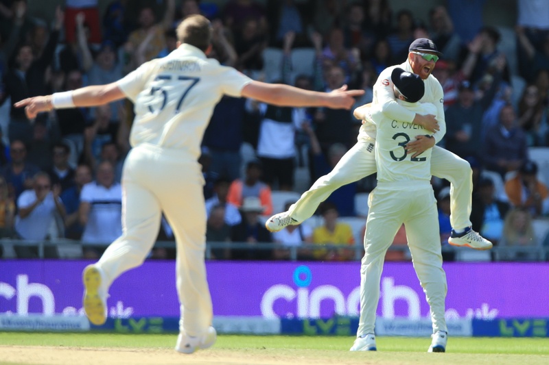 LEEDS: England's Jonny Bairstow leaps into the arms of England's Craig Overton after Overton takes the catch to dismiss India's Rishabh Pant off the bowling of England's Ollie Robinson (left) for 1 run on the fourth day of the third cricket Test match between England and India at Headingley cricket ground in Leeds, northern England, yesterday. – AFPn