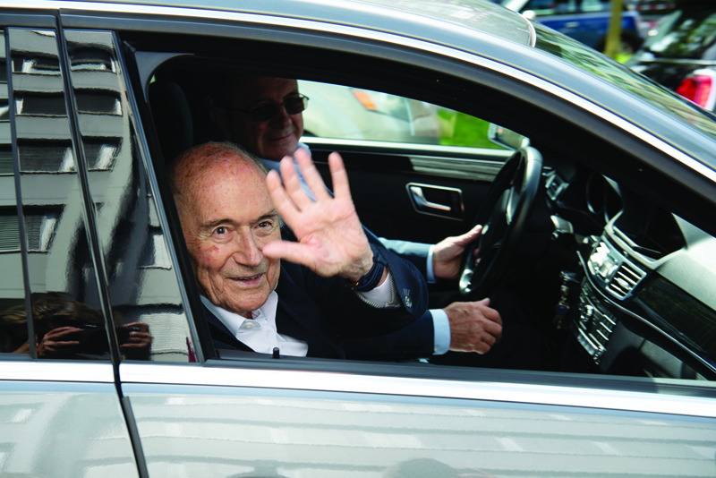 ZURICH: Former president of World football's governing body FIFA, Sepp Blatter, waves as he leaves the building of the Office of the Attorney General of Switzerland to attend a hearing in Zurich yesterday. - AFPn