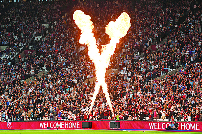 LONDON: A fire display and 'Welcome Home' signs greet West Ham fans as they take their seats ahead of the English Premier League football match between West Ham United and Leicester City at The London Stadium, in east London on Monday. - AFPn