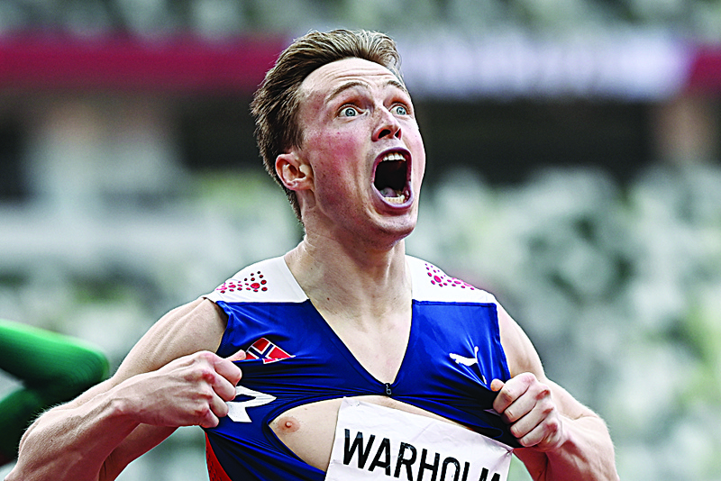 TOKYO: Norway's Karsten Warholm reacts after winning and breaking the world record in the men's 400m hurdles final during the Tokyo 2020 Olympic Games at the Olympic Stadium in Tokyo yesterday. - AFPn