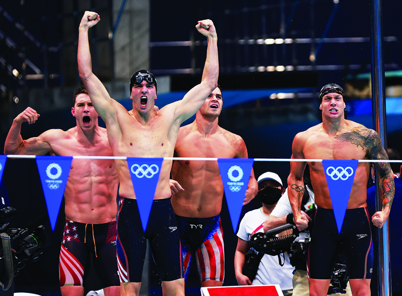 TOKYO: (From left) USA's Ryan Murphy, Zach Apple, Michael Andrew and Caeleb Dressel celebrate winning to take gold in the final of the men's 4x100m medley relay swimming event during the Tokyo 2020 Olympic Games at the Tokyo Aquatics Centre in Tokyo yesterday. - AFPn