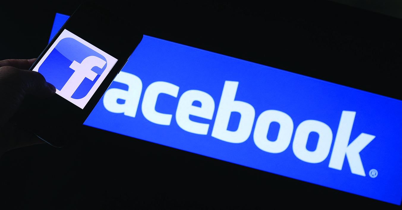 This file photo illustration shows the Facebook logo on a smartphone in front of a computer screen in Los Angeles. - AFPn