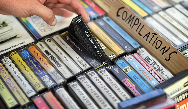 Giorgio Carbone, co-founder of Mars Tapes poses in his shop in Manchester, north west England on September 4, 2021. - Tucked away in a corner of the top floor of an indoor market in Manchester, northwest England, lies the last shop in Britain dedicated to selling cassettes. (Photo by PAUL ELLIS / AFP)