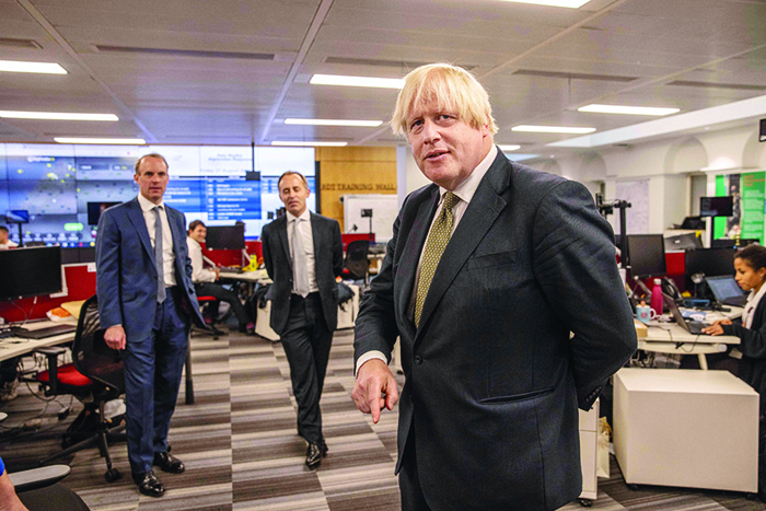 LONDON: Britain’s Foreign Secretary Dominic Raab (L) and Britain’s Prime Minister Boris Johnson (R) tour with Director General, Tom Drew (C) on a visit to The Foreign, Commonwealth and Development Office Crisis Centre at the Foreign Offices in London, to see how they are supporting and monitoring the ongoing evacuations in Afghanistan. —AFP