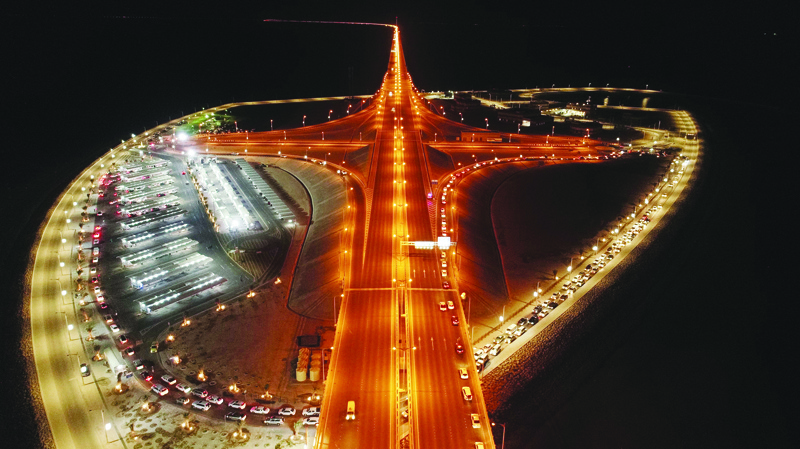 An aerial photo taken on Sept 7, 2021 shows cars lining up on the road near a drive-thru vaccination center on Jaber Causeway. - Xinhua n