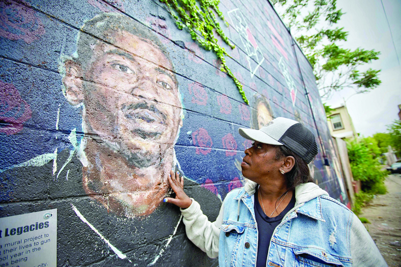 WASHINGTON: DC resident Seditra Brown, 49, stands next to a mural depicting her son Paris Brown in Washington, DC. - AFP n