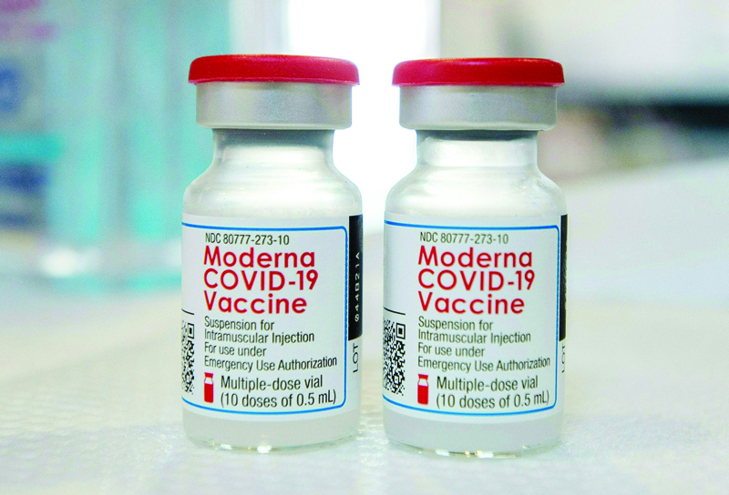 NORWOOD: Moderna vials sit on a table before they are loaded into syringes at a mobile COVID-19 vaccination clinic in Bridgeport, Connecticut. - AFP n