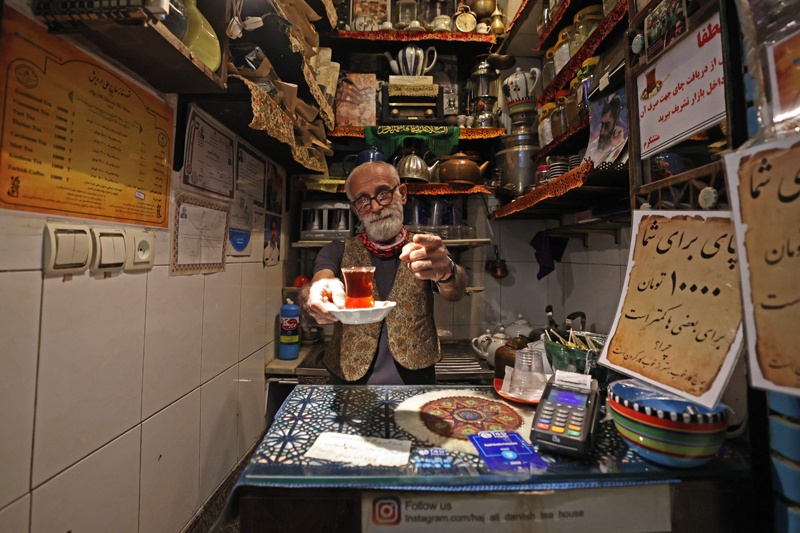 Owner Kazem Mabhutian, 63, serves tea at the smallest and oldest teahouse tucked away in an alleyway of the Grand Bazaar in the Iranian capital Tehran.—AFP photosn