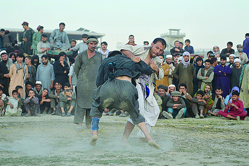KABUL: Fighters from around Afghanistan perform their judo and wrestling skills during a gathering in Chaman-e-Huzuri park, downtown Kabul. - AFPn