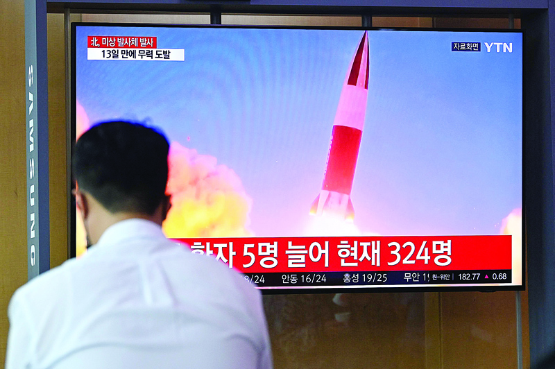 SEOUL: People watch a television news broadcast showing file footage of a North Korean missile test, at a railway station yesterday after North Korea fired an 'unidentified projectile' into the sea off its east coast.- AFP n