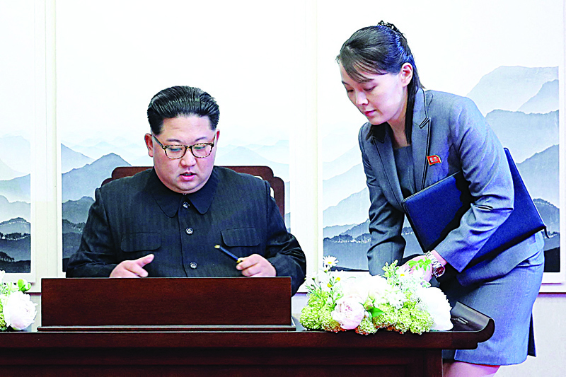 PANMUNJOM: In this file picture, North Korea's leader Kim Jong Un (left) signs the guest book next to his sister Kim Yo Jong during the Inter-Korean summit at the Peace House building on the southern side of the truce village of Panmunjom. - AFP n