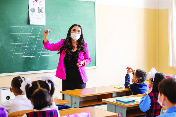 ULAANBAATAR: A teacher speaks to students during a class at the beginning of the new semester in Ulaanbaatar, the capital of Mongolia yesterday,  after schools and kindergartens were closed since January 2020 amid the COVID-19 pandemic. — AFP